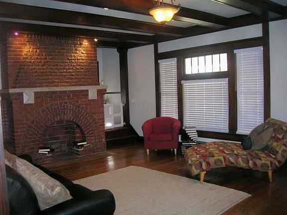 Large living area with great fireplace,beamed ceilings, and recessed lighting