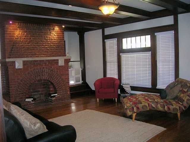 Large living area with great fireplace,beamed ceilings, and recessed lighting