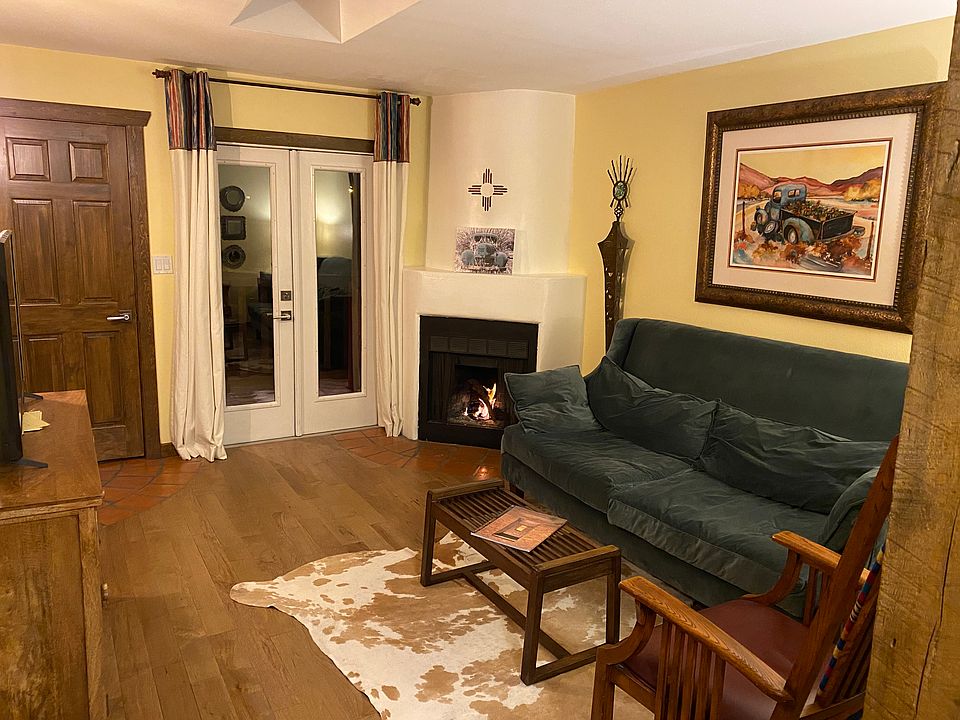 Living room: hard wood floors, kiva fireplace, French doors opening to balcony