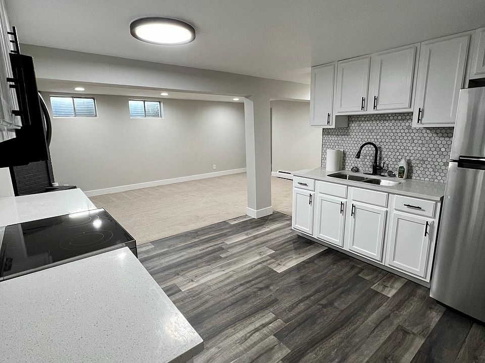 Newly remodeled with white cabinets, hardwood floors, subway tile back-splash, stainless steel appliances, and white quartz counters.