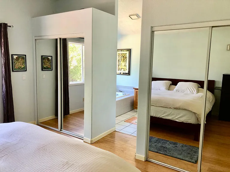 Primary Bedroom, opens into large private bath. Double closets, looks out onto the scenic backyard and forest. Many bird songs, frog songs and crickets are heard from this room!
