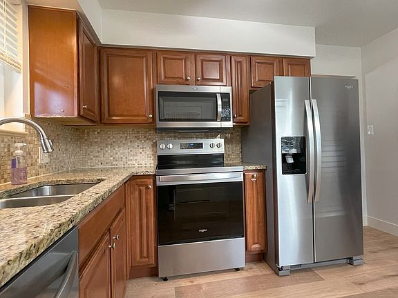 Granite countertops, Lazy Susan corner cabinet and ceiling fan.