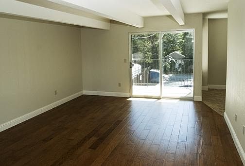 View of balcony, from front entry area. Dining area and kitchen are to the right.