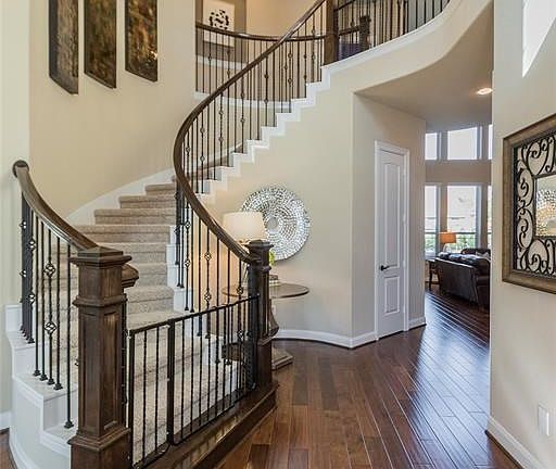 As you enter the home you will notice the beautiful wood flooring and sweeping ceilings.
