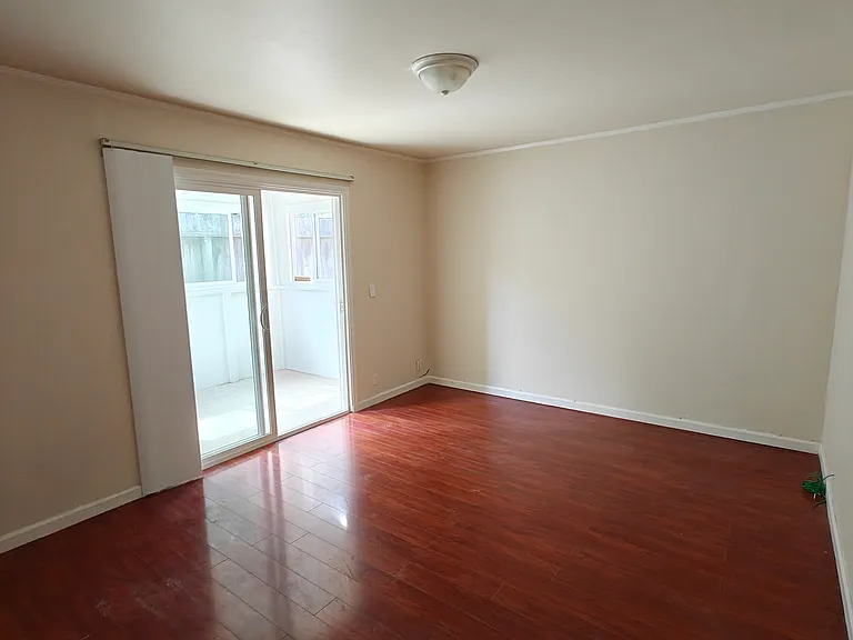 large bedroom with backyard access