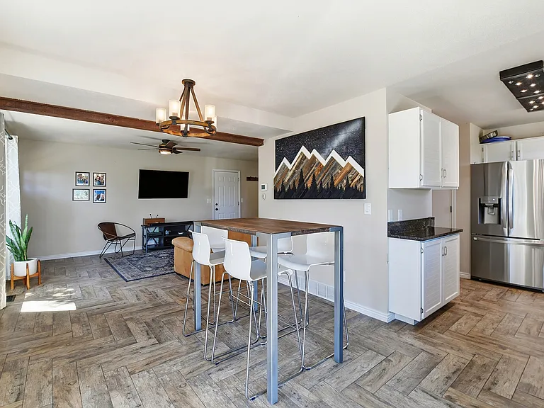 The bright, open kitchen flows seamlessly into the dining and living areas, making it easy to cook, gather, and enjoy time with family and friends.