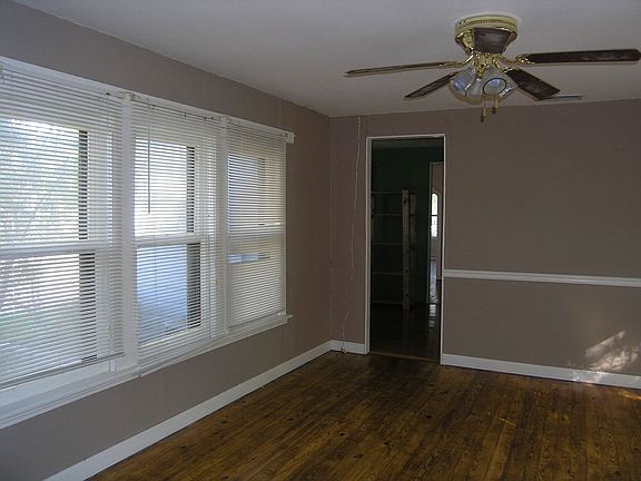 2nd living area in center of home has windows on each side and hardwood floors