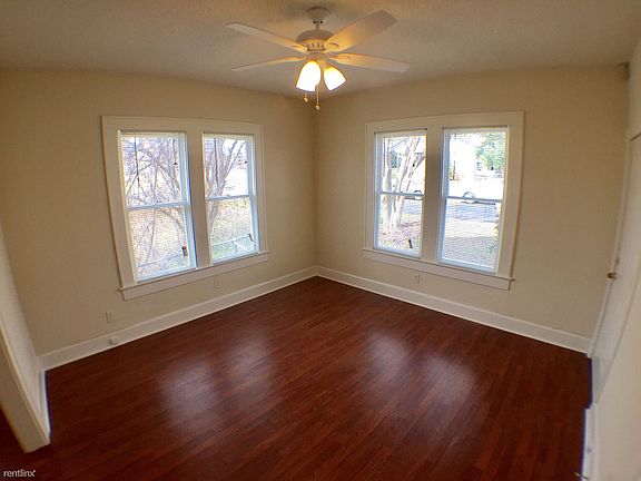 The bright living room serves as the entry into the charming