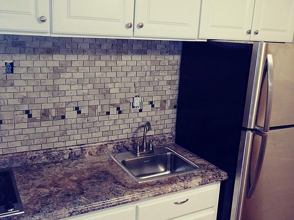 New counter, sink, fridge and backsplash