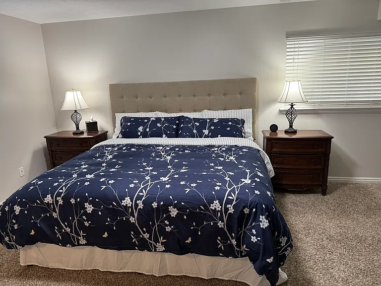 King size bed and two nightstands with lights, Kleenex, and Alexa