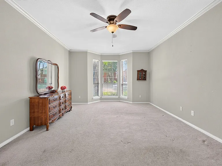 Primary Bedroom with bay window and vaulted ceiling