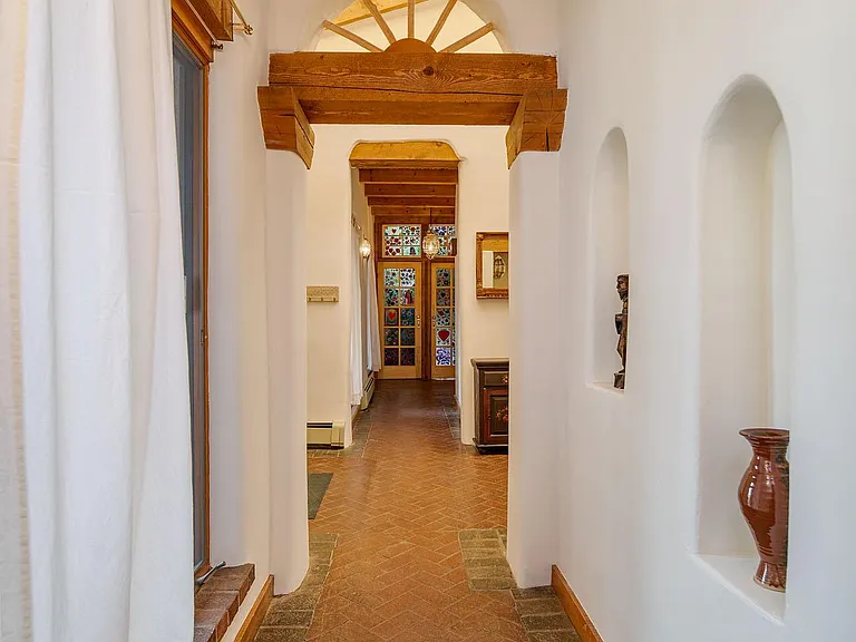 Brick hallway to bedroom