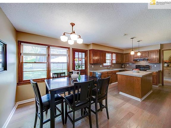 Beatifully updated kitchen with new hardwoods, backsplash, Quartz counters and lighting.