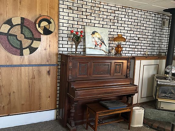 Upright Piano and gas stove in Living room