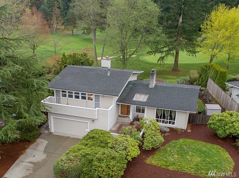 Welcome home to Fairwood Greens! This spacious mid-century modern style home is beautifully situated on the 17th green! You'll love the architectural details beginning at the Craftsman front door, atrium in the entry, living room fireplace and lovely fixtures. The updated open concept kitchen boasts high-end appliances, a large island, double ovens and more. Made for entertaining, you'll love the spacious living and dining rooms with views to the landscape and golf course beyond. Extend your gatherings outside to two expansive patios and the tranquil view. The master suite features a remodeled ensuite bath and large sitting area. There are two additional guestrooms on the upper floor, and each of these lead to a private deck! There is one additional bedroom on the lower floor, along with a cozy family room with a free-standing gas fireplace and a slider leading out to the lower patio. 