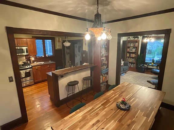 Kitchen open to dining room and front parlor. Big table space and built in bar for three.