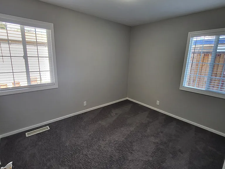 Bedroom #2 with new paint, blinds, carpeting, and lighting.