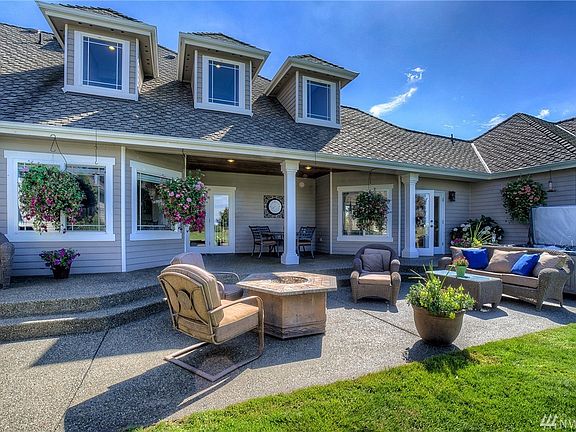 Back outdoor patio is well-suited for both peaceful mornings or lively gatherings. Covered area is added living space for year-round enjoyment. You won't want to miss the sunset views!
