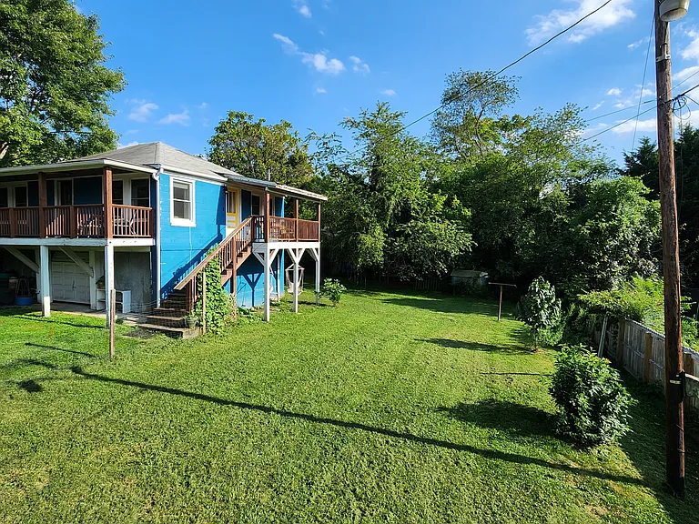 Fenced back yard. Long clothesline. Chicken coop & bunny hutch all the way back.