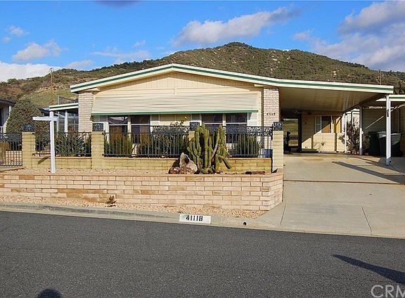 Front View, large carport with electric sliding wrought iron gate
