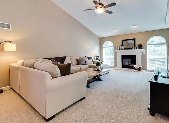 Spacious living room with vaulted ceilings, gas fireplace, and tons of natural light