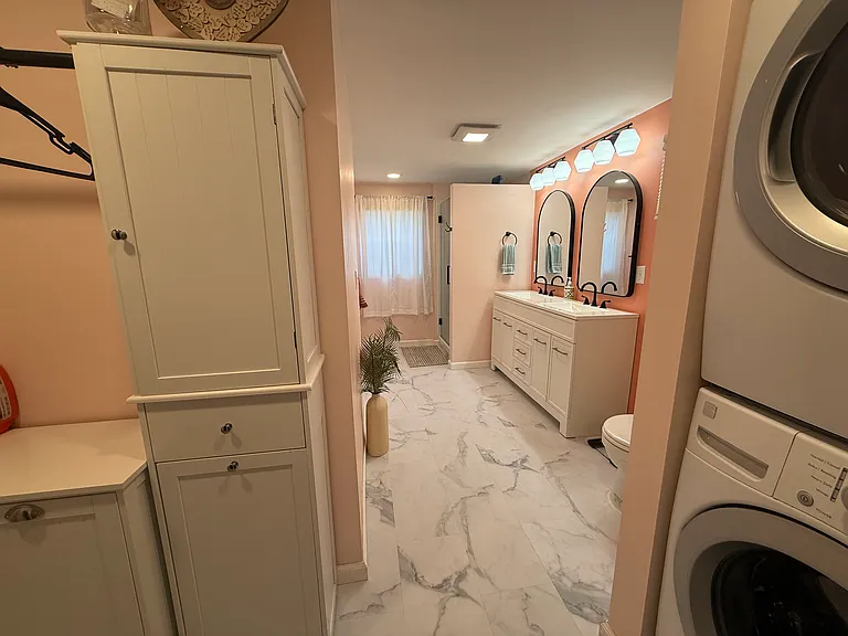 Laundry nook including folding station in master bathroom