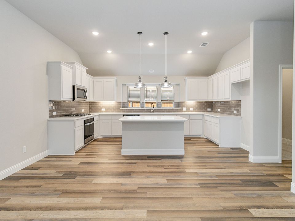 McKinney floor plan featuring open-concept living, three bedrooms, two bathrooms, and a covered pati