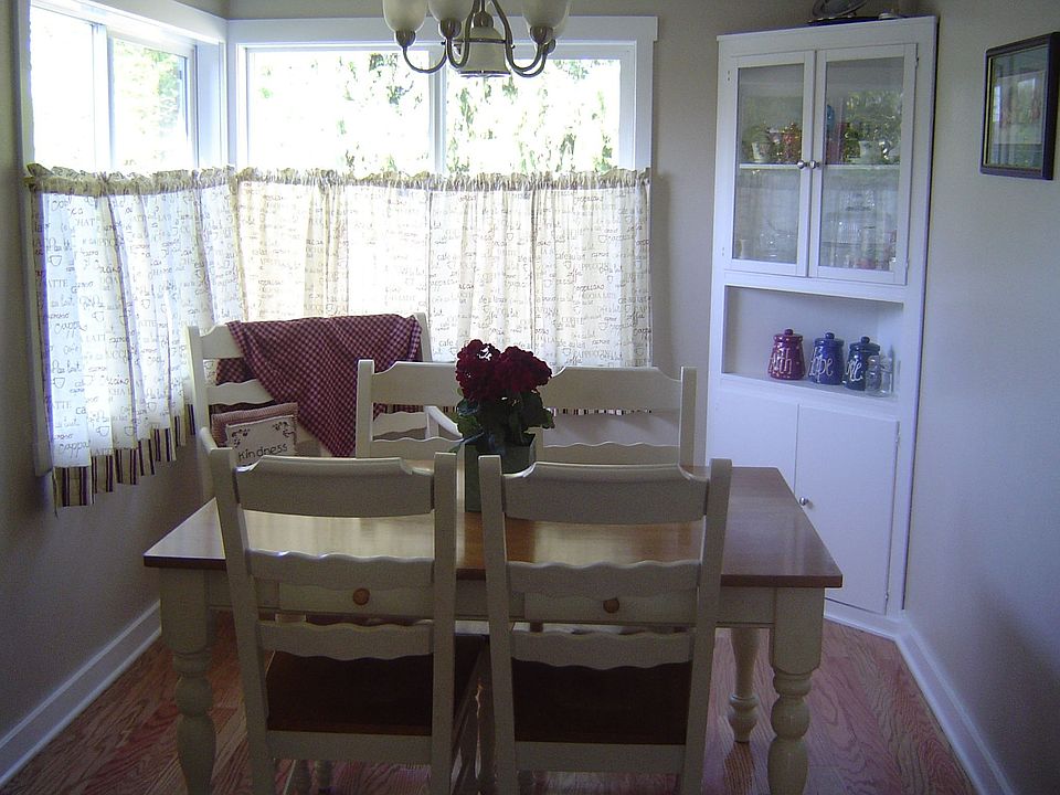 Cozy dining room with built in hutch, new hardwood floors and vinyl windows.