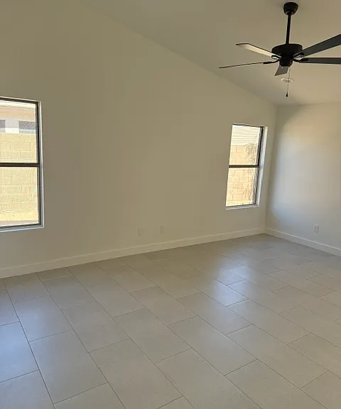 Light and Bright primary bedroom with vaulted ceilings and new fans throughout