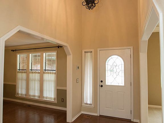 Welcoming 2 Story Entry with gleaming hardwood floors and new oil rubbed bronze light fixture.
