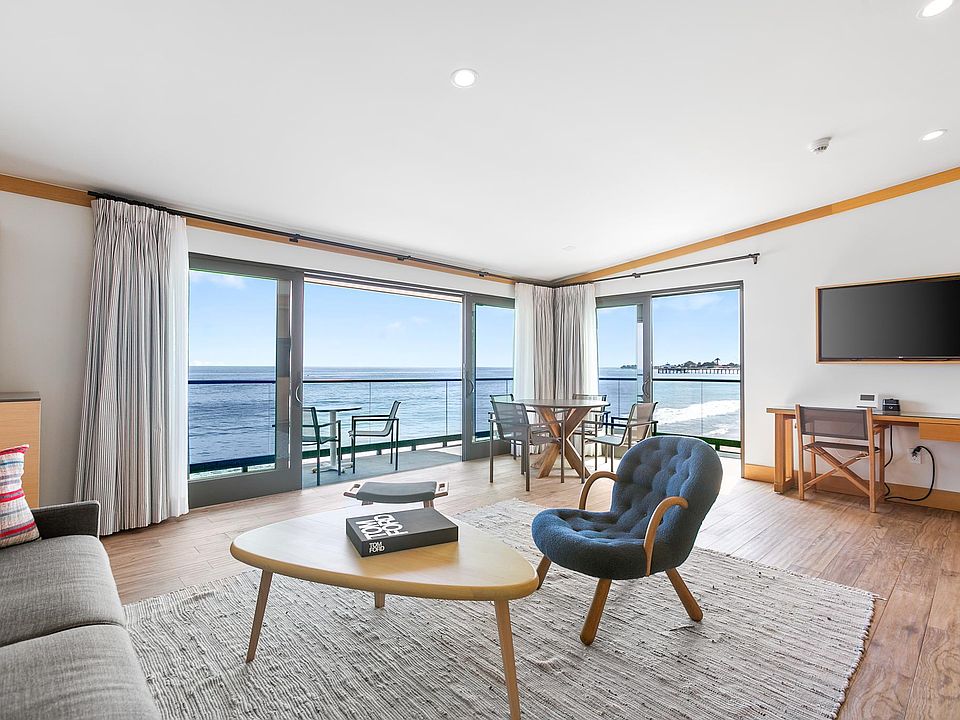 Expansive glass doors and windows providing clear views of the ocean