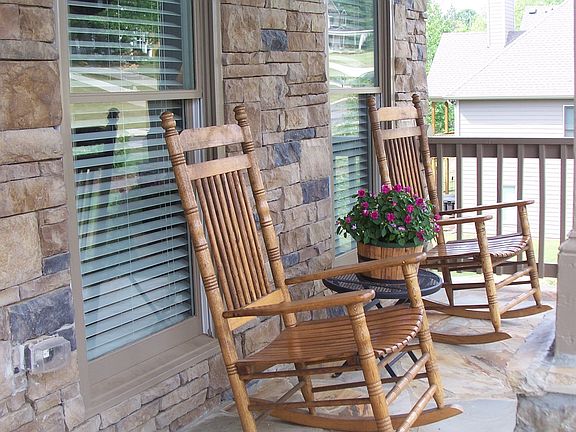 Beautiful stacked stone, rocking chair front porch
