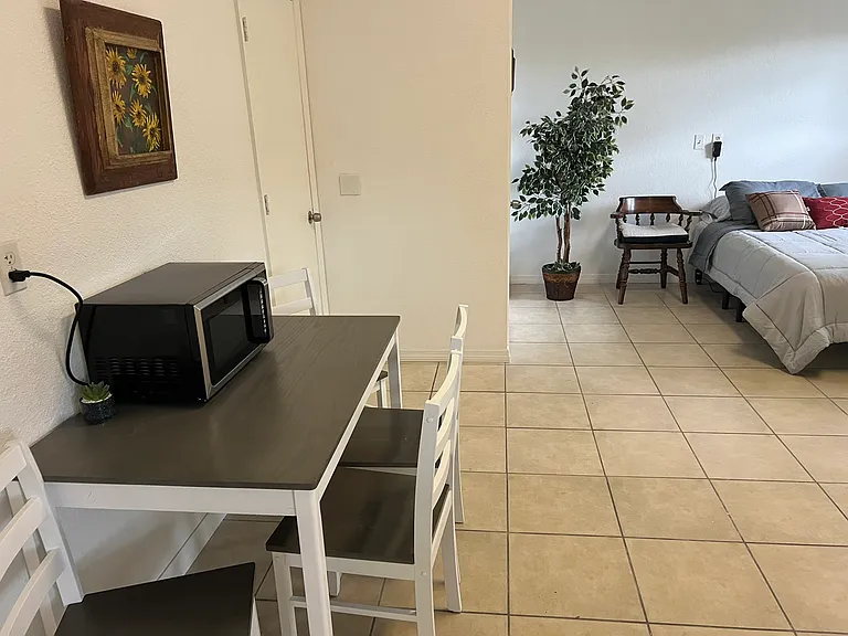 There is a table that seats 4 for study or serving a meal. The microwave is new, and handy for a quick heat-up of food or drinks.