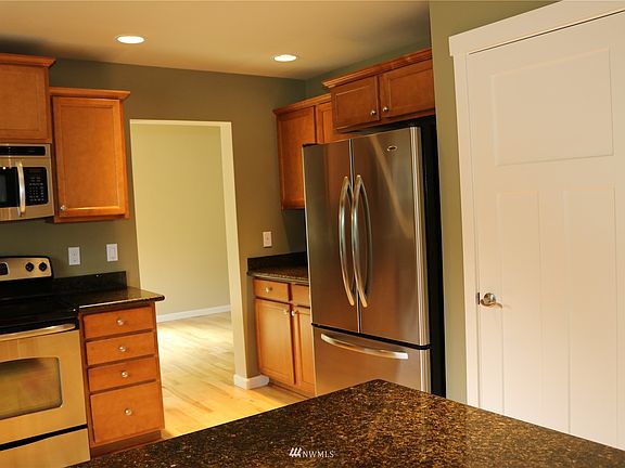 Granite counters, stainless appliances, and beautiful cabinets.>