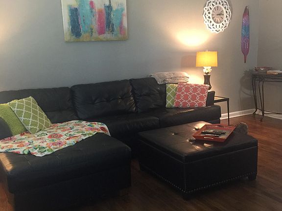 Spacious Living Room. The Kitchen (not shown) has a Granite Island and Tiled Floor and Backsplash. It has a Refrigerator and Stove with a Vent Hood. The Sink overlooks the back yard. The Bathroom has been Updated. It has a Shower/Tub combo. There is pl