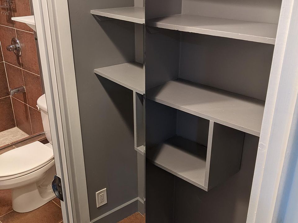 bathroom storage closet with mirrors bi-fold door