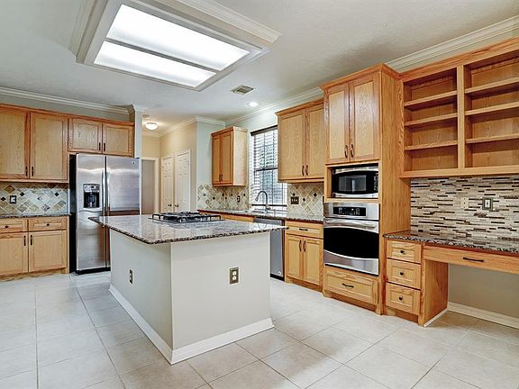 Granite countertops, stainless appliances and refrigerator, washer and dryer included. Double door pantry in back across from utility room with storage. Convenient built-in desk with shelving and added storage.