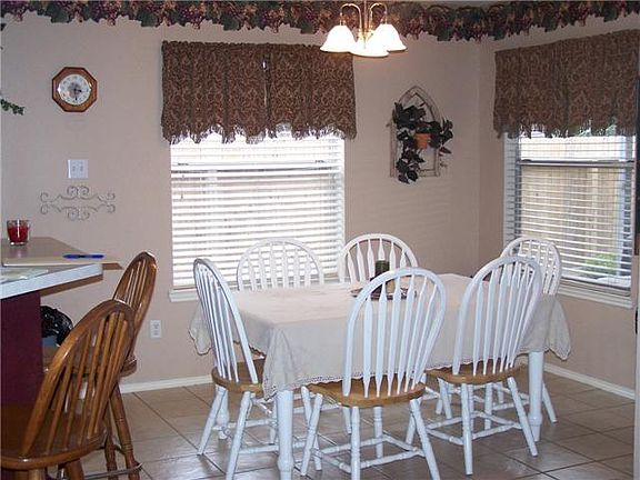    Light and bright breakfast room. Large area with room for table for six. Notice the breakfast bar that will be the perfect place for kids.