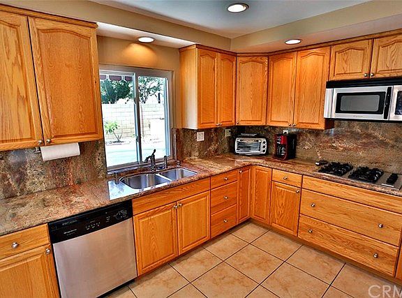 Remodeled kitchen with granite counter top and stainless steel appliances.