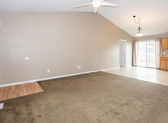 Neutral colors make this home bright and airy.  Door to the left of the slider is the main floor laundry.