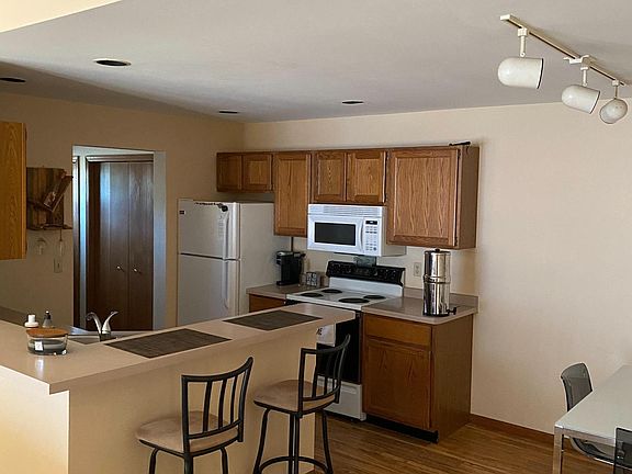 Dining area and Kitchen looking in to Laundry Room.