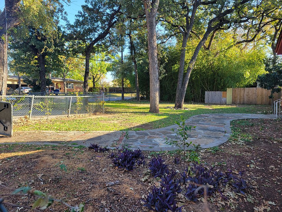 Large front yard with mature trees.