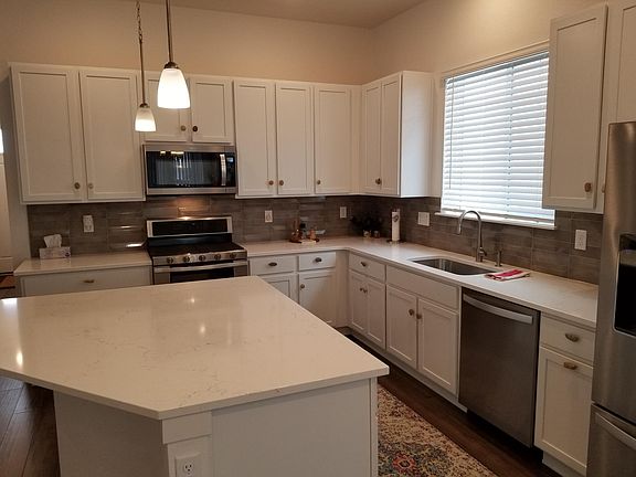 New appliances including double oven and gas stove top. Cabinets fully stocked with dishes/cookware/small appliances.