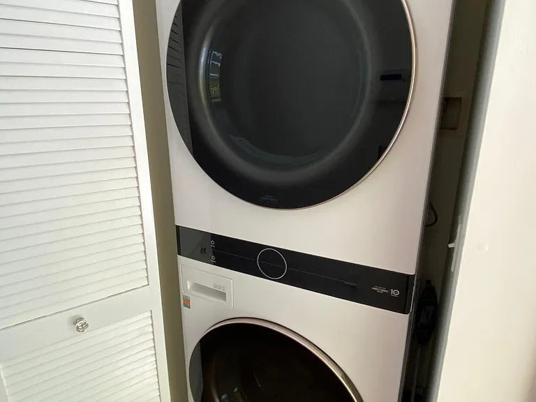 washer dryer in a closet in the hallway