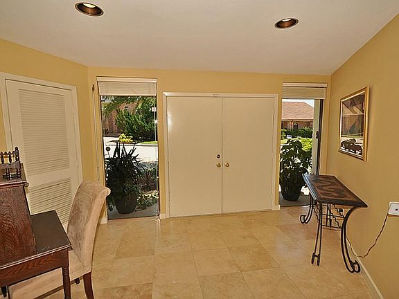 Inviting double door entry adorned by floor to ceiling windows. Large walk in close to the right whe