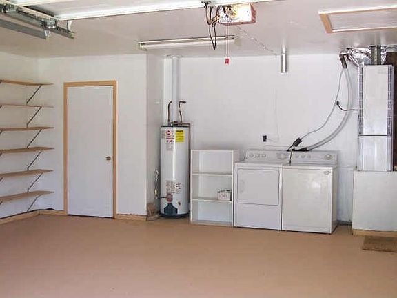 Wonderful Spacious Garage With New Doors and Seperate Storage Area!