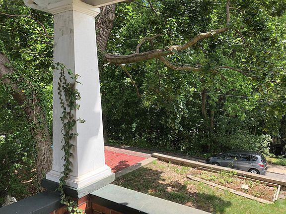 Front porch view, fully wooded lot across street, one of the few fully-shaded streets in Staunton, great for short strolls.