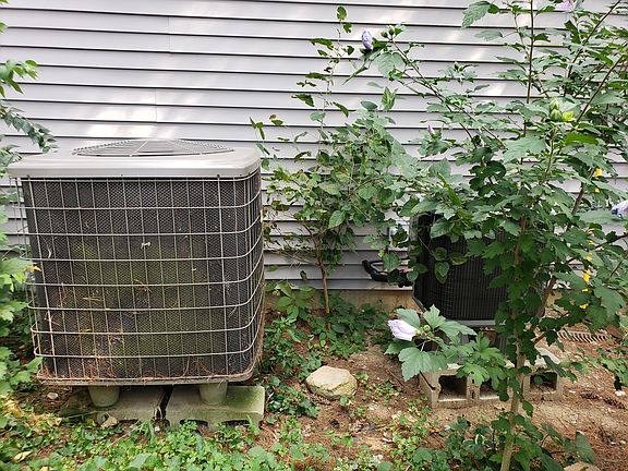 2 outside hvac units on westsideofhousebehindtrailer