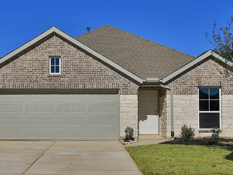 Elegant single-story home in Cypress Green with classic brick facade and spacious double garage.