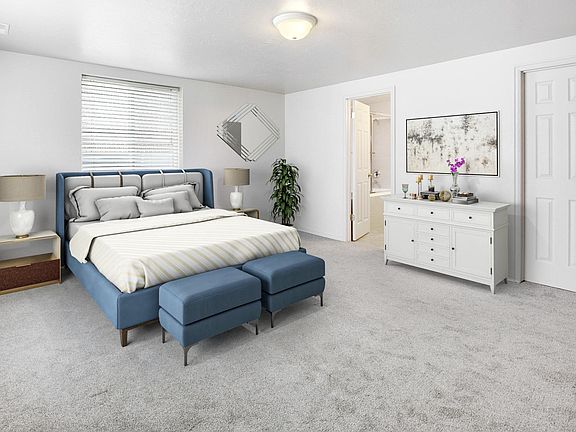 Master bedroom with two large windows, walk in closet and view into master bathroom.